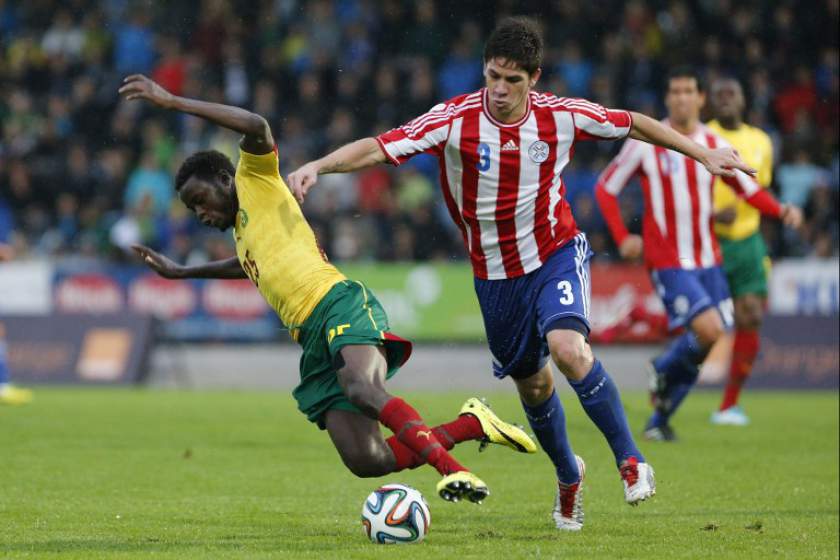 Cameroonu00e2u20acu2122s midfielder Edgar Salli (left) vies for the ball with Paraguayu00e2u20acu2122s defender Danilo Ortiz during the World Cup 2014 friendly match between Cameroon and Paraguay, in Kufstein, Austria, May 29, 2014. u00e2u20acu201d AFP pic