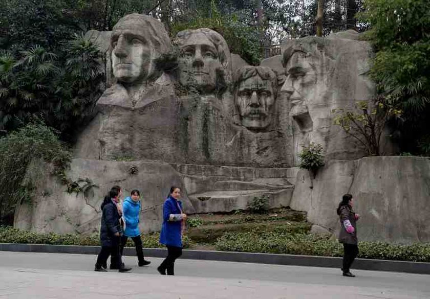This photo taken on on February 21, 2014 shows people walking past a copy of Mount Rushmore at a park in Chongqing. u00e2u20acu201d AFP pic