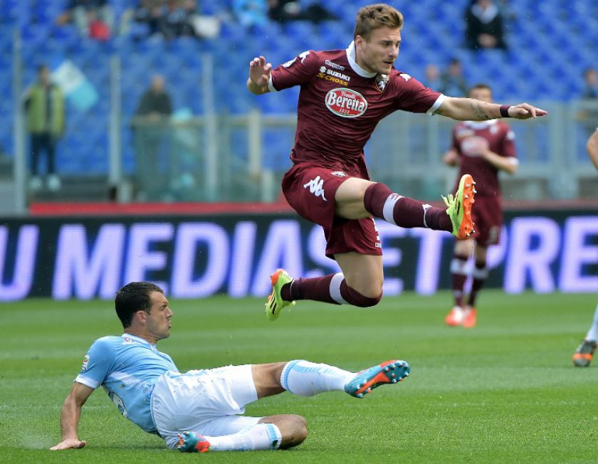 Torinou00e2u20acu2122s forward Ciro Immobile vies with Laziou00e2u20acu2122s Argentinian defender Diego Novaretti (left) during the Italian Serie A match between Lazio Rome and Torino on April 19, 2014 in Rome. u00e2u20acu201d AFP pic