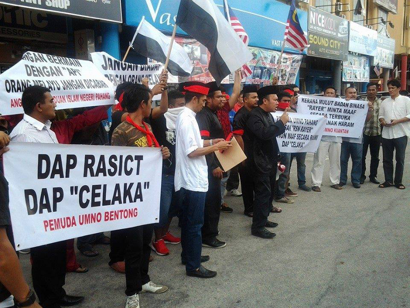 A group claiming to be Umno members hold banners while protesting outside the DAP office in Kuantan, on May 23, 2014. u00e2u20acu201d Picture courtesy of The Rocket