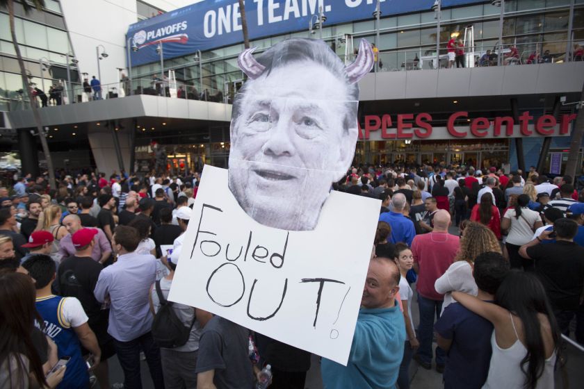 A supporter holds a photo cutout of Los Angeles Clippers owner Donald Sterling while standing in line for the NBA Playoff game 5 between Golden State Warriors and Los Angeles Clippers at Staples Center in Los Angeles, California April 29, 2014. u00e2u20acu201d Reuter