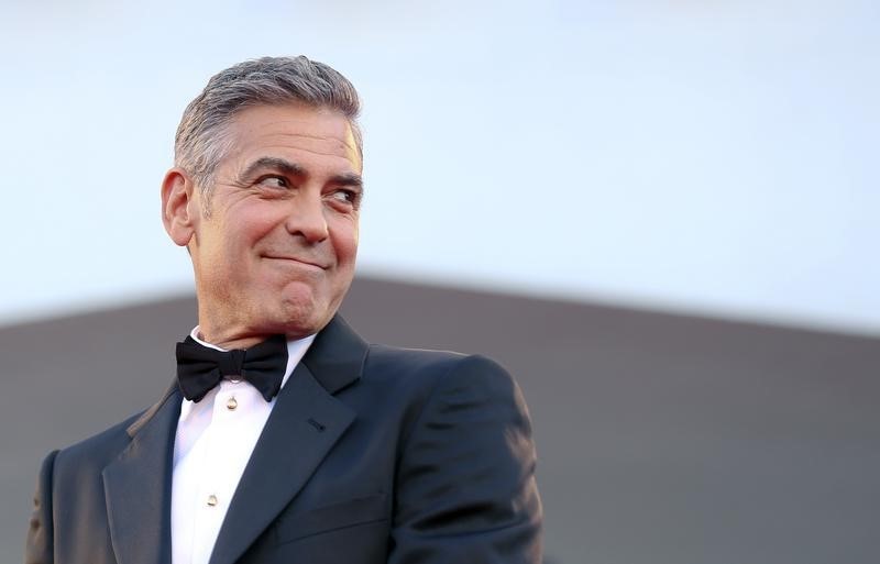US actor George Clooney smiles as he arrives on the red carpet for the premiere of u00e2u20acu02dcGravityu00e2u20acu2122 at the 70th Venice Film Festival in Venice August 28, 2013. u00e2u20acu201d Reuters pic