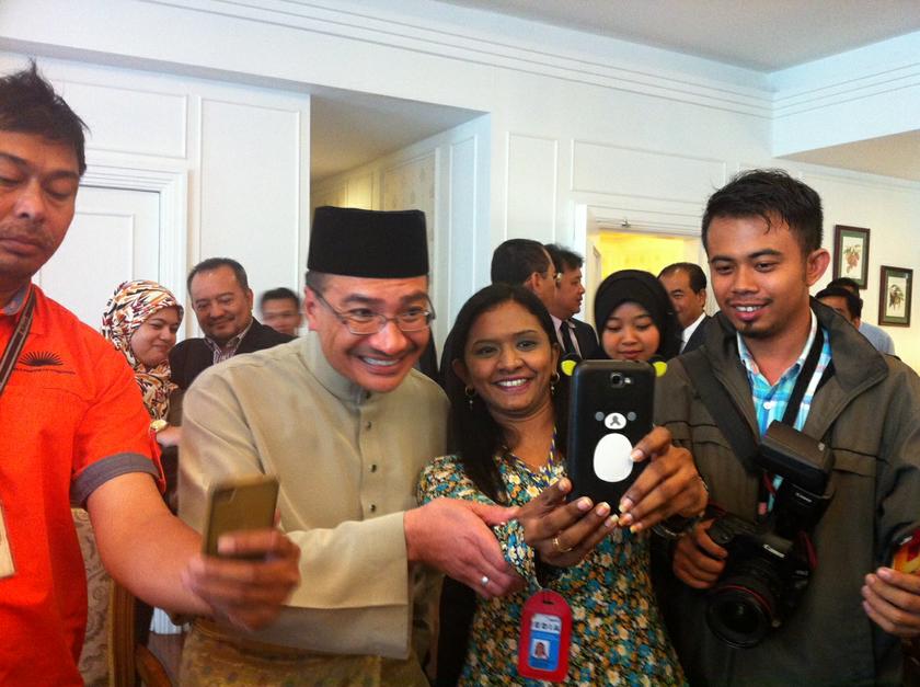 Acting transport minister Datuk Seri Hishammuddin Hussein takes a selfie with a journalist after giving an interview on MH370. u00e2u20acu201d Picture by Boo Su-Lyn