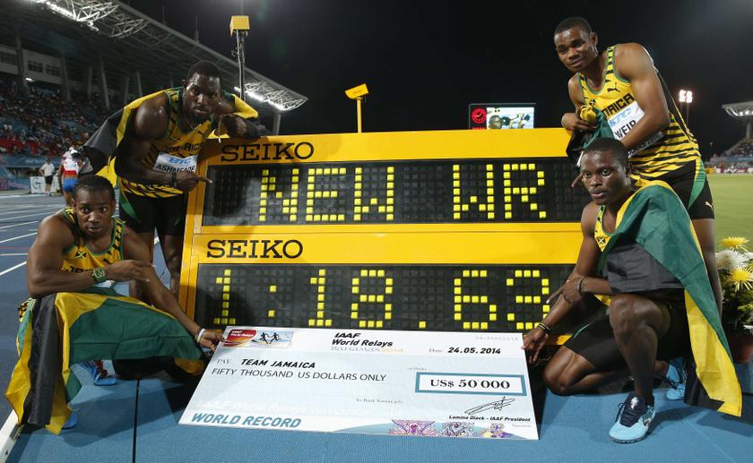 Jamaicau00e2u20acu2122s 4x200 relay team poses next to the clock after they set a new world record while winning the 4x200 metres relay at the IAAF World Relays Championships in Nassau, Bahamas, May 24, 2014. u00e2u20acu201d Reuters pic