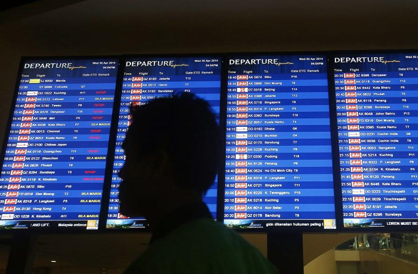 A man walks in front of a flight board at Kuala Lumpur International Airport 2 (KLIA2) in Sepang April 30, 2014. u00e2u20acu201d Reuters pic