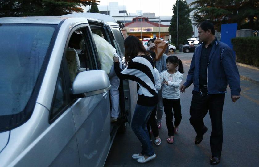 Relatives of passengers onboard Malaysia Airlines Flight MH370 board a car as they leave Lido hotel, where Malaysia Airlines provided accommodation for family members, in Beijing May 2, 2014. u00e2u20acu2022 Reuters pic