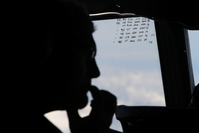 A crew member aboard a Royal New Zealand Air Force P-3K2 Orion aircraft during a search for the missing Malaysian Airlines flight MH370 in this March 29, 2014 file photo.u00c2u00a0u00e2u20acu201d Reuters pic