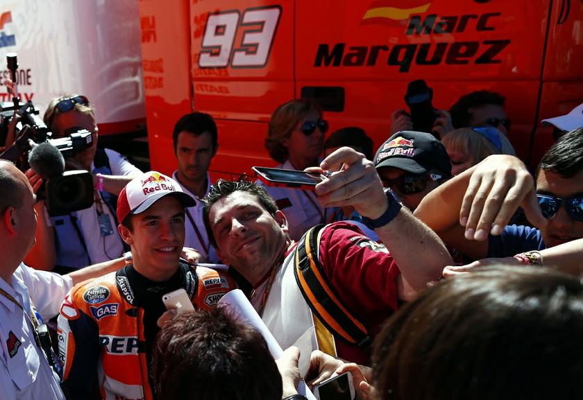 Honda MotoGP rider Marc Marquez (left) of Spain poses for a picture with a fan in the paddock during the Spanish Grand Prix in Jerez de la Frontera, southern Spain, May 3, 2014. u00e2u20acu201d Reuters pic