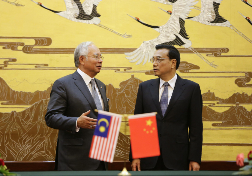 Prime Minister Datuk Seri Najib Razak (left) speaks to China's Premier Li Keqiang during a signing ceremony at the Great Hall of the People, in Beijing, May 29, 2014. u00e2u20acu201d Reuters pic