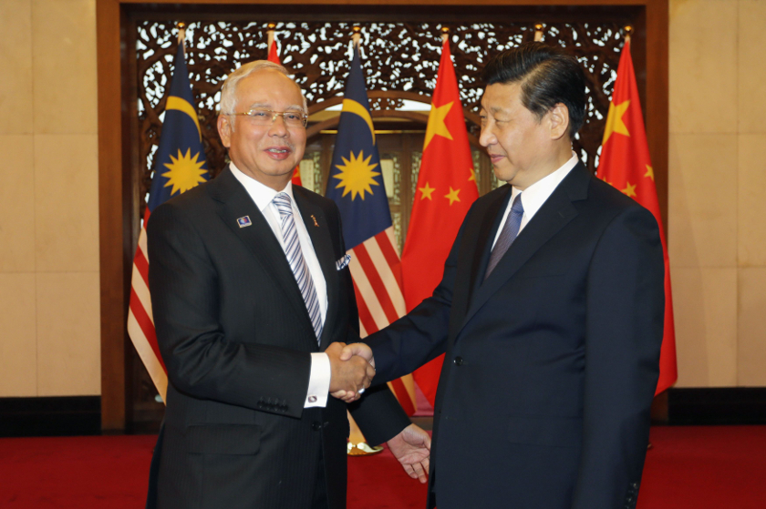 Malaysia's Prime Minister Najib Razak (left) shakes hands with China's President Xi Jinping during a meeting at the Diaoyutai State Guesthouse in Beijing, May 30, 2014. u00e2u20acu201d Reuters pic