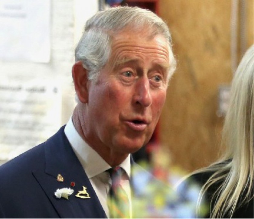 File picture shows Prince Charles watching the Royal Crest appearing in a specially-designed mirror used for advertising, May 21, 2014 in Winnipeg, Canada. u00e2u20acu201d AFP pic