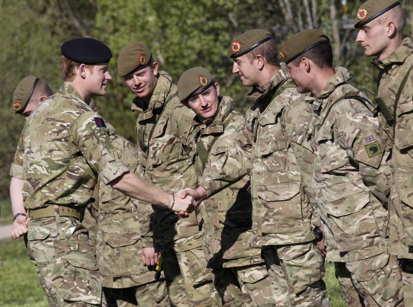 Britain's Prince Harry (L) shakes hands with soldiers from the British Army during