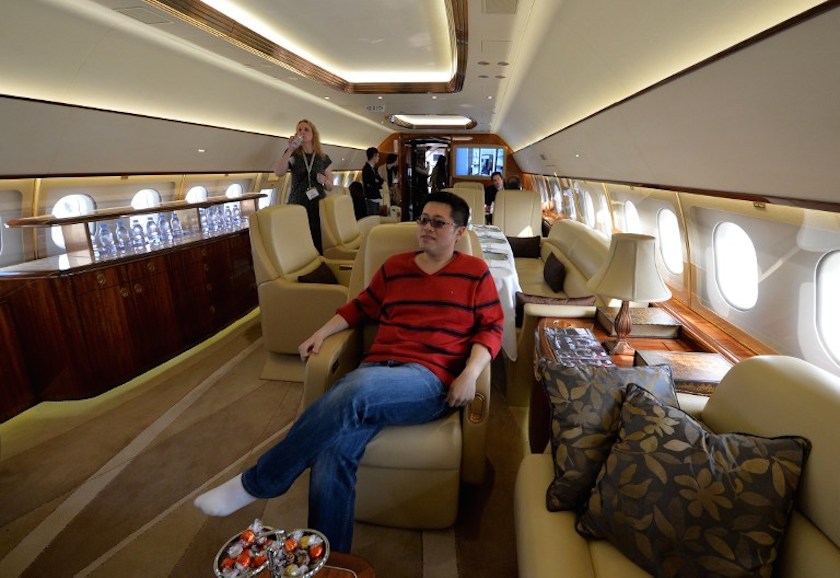 A Chinese man tries out the interior on an Airbus A319 private business jet during the Asian Business Aviation Conference and Exhibition (ABACE2014) at the Shanghai Hongqiao airport on April 14, 2014. u00e2u20acu201d AFP pic