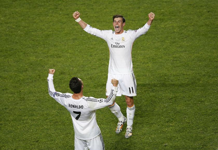 Real Madridu00e2u20acu2122s Gareth Bale (top) celebrates with his team mate Cristiano Ronaldo at the end of their Champions League final match against Atletico Madrid at the Luz Stadium in Lisbon May 24, 2014. u00e2u20acu201d Reuters pic