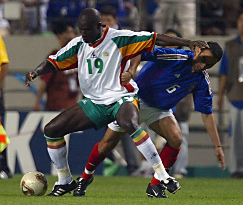 File picture shows Senegalese defender Pape Malick Diop being challenged by French midfielder Youri Djorkaeff (right) during the opening match of the 2002 FIFA World Cup in Seoul, 31 May 2002. u00e2u20acu201d AFP pic