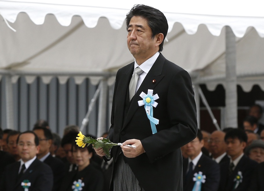 Japan's Prime Minister Shinzo Abe walks to offer a flower for Japan's unidentified war dead, during a ceremony at Chidorigafuchi National Cemetery in Tokyo May 26, 2014. u00e2u20acu201du00c2u00a0Reuters pic