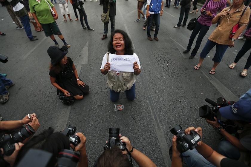 Reporters take pictures of a protester against military rule holding a sign at the Victory Monument in Bangkok May 26, 2014. u00e2u20acu201du00c2u00a0Reuters pic