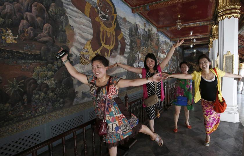 Chinese tourists pose for a picture inside the Grand Palace in Bangkok May 24, 2014. u00e2u20acu201d Reuters pic