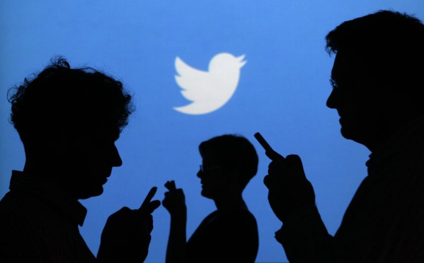 People holding mobile phones are silhouetted against a backdrop projected with the Twitter logo in this illustration picture taken in Warsaw in this September 27, 2013 file photo. u00e2u20acu201d Reuters pic