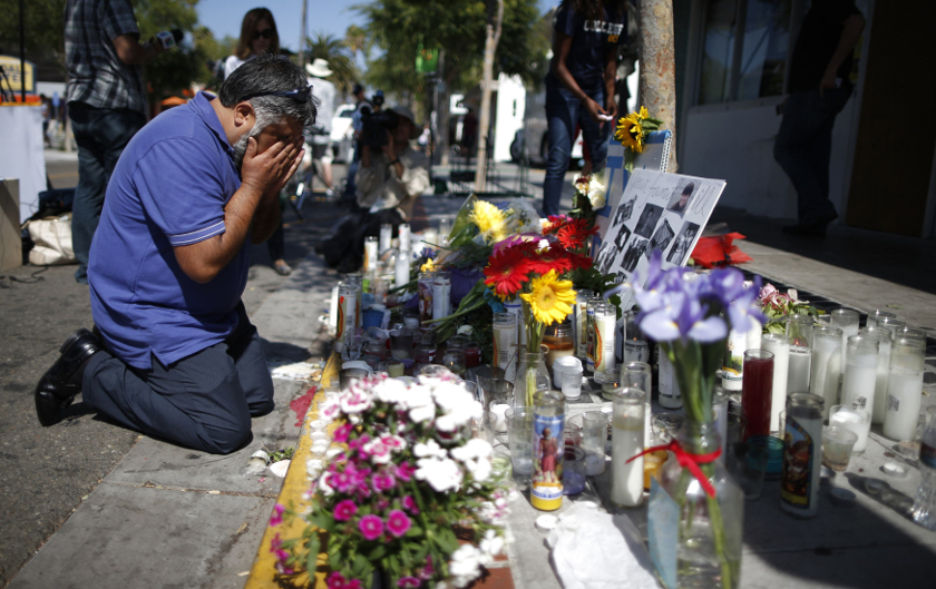 A man cries in front of a makeshift memorial for 20-year-old UCSB student Christopher Michael-Martinez after series of drive-by shootings that left 7 people dead in the Isla Vista neighbourhood of Santa Barbara, on May 25, 2014.