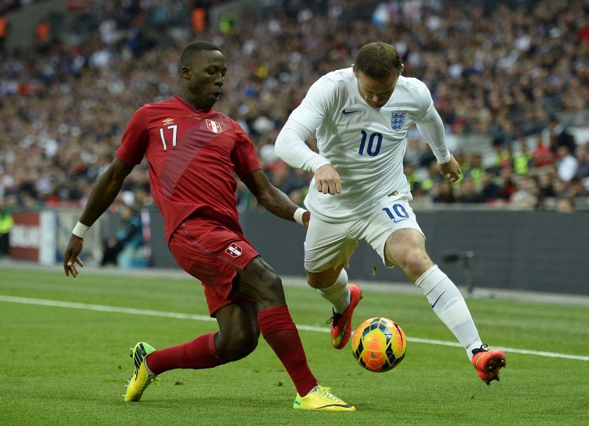 England's Wayne Rooney (right) attempts to evade the challenge of Peru's Luis Advincula during their international friendly football match at Wembley Stadium in London May 30, 2014.  u00e2u20acu201d Reuters pic