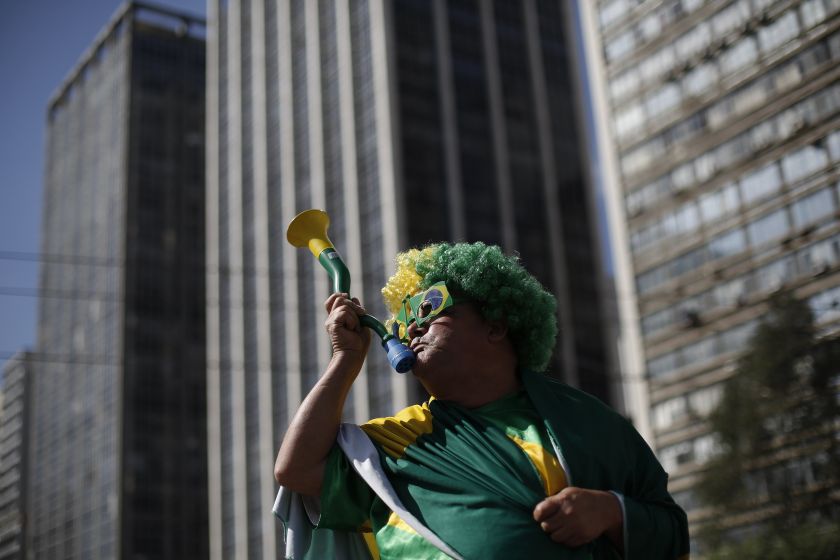 Jeremias Do Prado, a 47-year-old decked out in an outfit matching the Brazilian flag in preparation for the 2014 World Cup, blows a horn along a street in Sao Paulo May, 30, 2014. u00e2u20acu201d Reuters pic