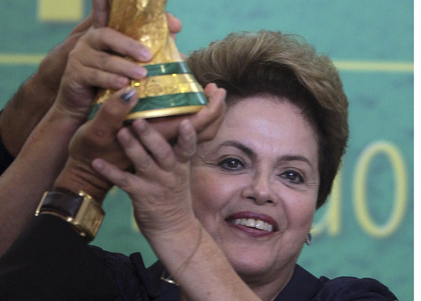 Brazil's President Dilma Rousseff holds up the World Cup trophy during a ceremony at the Planalto Palace in Brasilia, June 2, 2014. u00e2u20acu201d Reuters pic