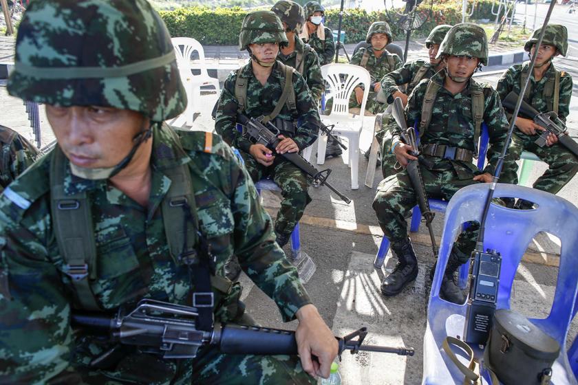 Thai soldiers take their positions near a pro-government u00e2u20acu02dcred-shirtu00e2u20acu2122 encampment in Bangkok's suburbs, a day after a coup was declared May 23, 2014. u00e2u20acu201d Reuters pic