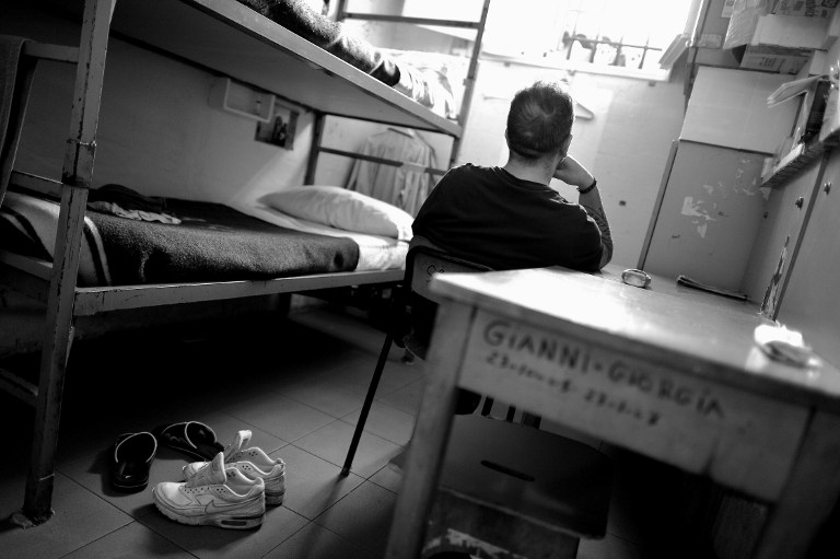 A prisoner sits in his cell at Regina Coeli prison in Rome on May 30, 2014. u00e2u20acu201d AFP pic