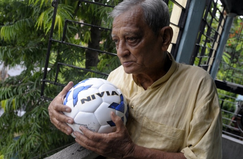 Indian football enthusiast Pannalal Chatterjee poses on his balcony with a football before going to his regular football practice at a local ground in Kolkata in this file photo dated June 12, 2010. u00e2u20acu201d AFP pic