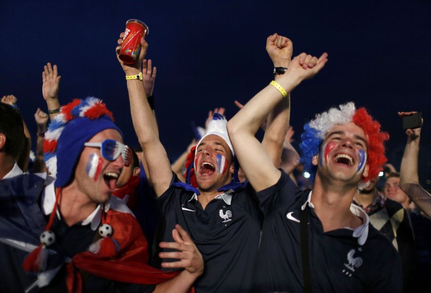 French football fans celebrate a goal as they watch the 2014 World Cup football match between France and Switzerland on a large screen at Copacabana beach in Rio de Janeiro, June 20, 2014. u00e2u20acu201d Reuter spic