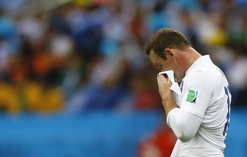 England's Wayne Rooney wipes his face during the 2014 World Cup Group D football match between Uruguay and England at the Corinthians arena in Sao Paulo June 19, 2014. u00e2u20acu201d Reuters pic