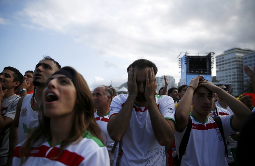 Iranian football fans react as they watch the 2014 World Cup football match between Argentina and Iran on a large screen at Copacabana beach in Rio de Janeiro, June 21, 2014. u00e2u20acu201d Reuters pic