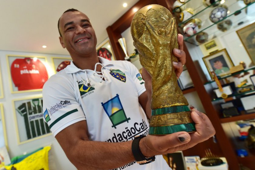 Former Brazilian national football team captain Cafu holds a replica of the FIFA World Cup trophy during an interview with AFP at his home in Barueri, metropolitan area of Sao Paulo, Brazil on May 29, 2014. u00e2u20acu201d AFP pic