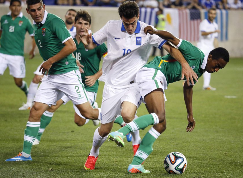 Greeceu00e2u20acu2122s Lazaros Christodoulopoulos (16) cuts between Boliviau00e2u20acu2122s Ronald Eguino (2) and Jaime Arrascaita (19) as they chase the ball during their friendly match, ahead of the 2014 World Cup, at the Red Bull Arena in Harrison, New Jersey, June 6, 2014. u00e2