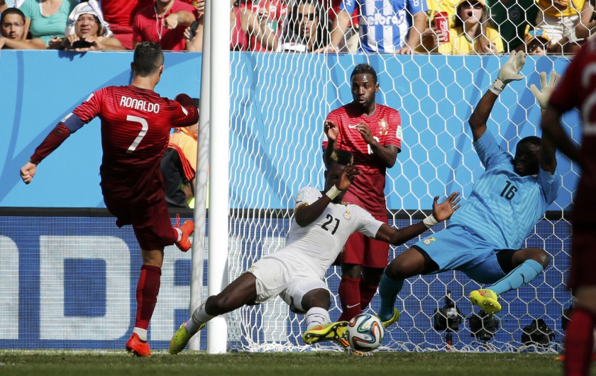 Portugalu00e2u20acu2122s Cristiano Ronaldo scores past Ghanau00e2u20acu2122s goalkeeper Fatau Dauda and John Boye during their Group G match at the Brasilia national stadium in Brasilia June 26, 2014. u00e2u20acu201d Reuters pic