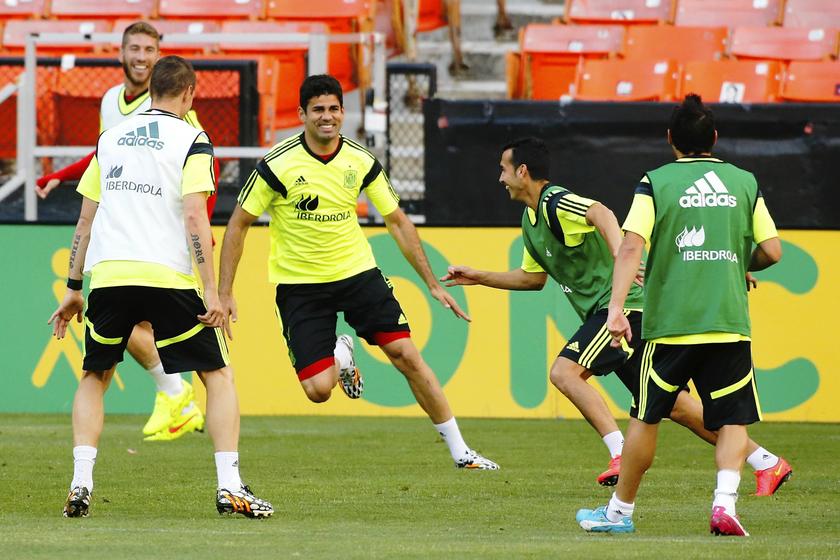 Spainu00e2u20acu2122s national soccer team player Diego Costa (centre left) chases his teammates during a warm-up drill at a training session at RFK Stadium in Washington June 5, 2014. u00e2u20acu201d Reuters pic