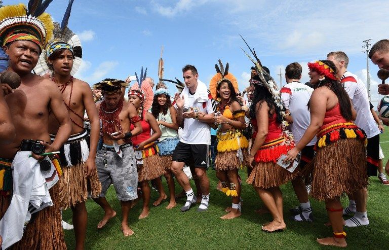 German forward Miroslav Klose (centre) dances with native Brazilians present to celebrate his 36th birthday at a training session of Germanyu00e2u20acu2122s national football team in Santo Andre on June 9, 2014 AFP