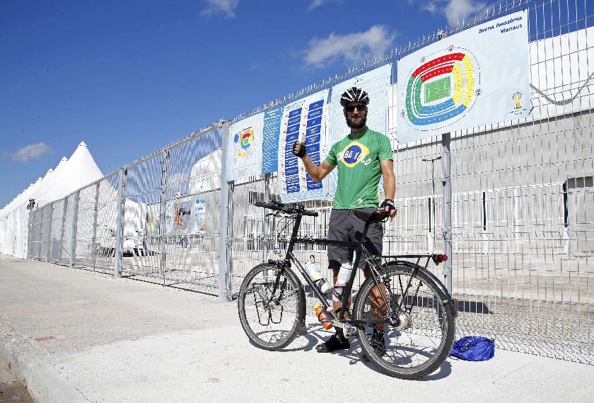 London accountant Andy Smith poses in front of Arena da Amazonia stadium where England and Italy will play for their first match of the World Cup, June 13, 2014 Reuters