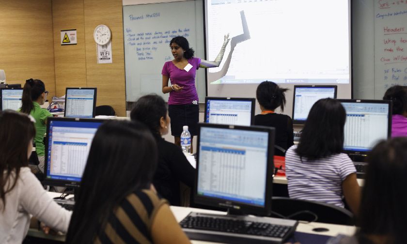 Domestic workers attend a class on Microsoft Excel in Singapore Reuters