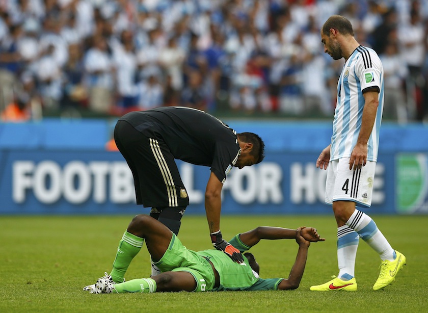 Nigeria's Michael Babatunde holds his wrist in pain after being hit with a shot from teammate Ogenyi Onazi during the 2014 World Cup Group F match between Argentina and Nigeria at the Beira Rio stadium in Porto Alegre June 26, 2014. u00e2u20acu201d Reuters pic