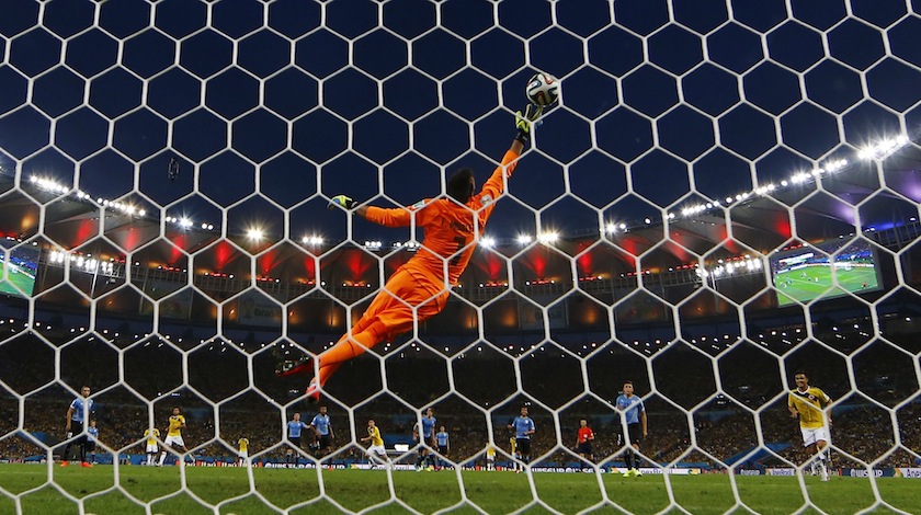 Colombia's James Rodriguez scores a goal against Uruguay's goalkeeper Fernando Muslera during their 2014 World Cup round of 16 game at the Maracana stadium in Rio de Janeiro June 29, 2014. u00e2u20acu201d Reuters pic