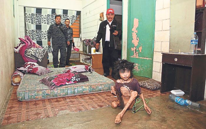 Immigration officers stunned to find the emaciated disabled teenager during their operation. The chance discovery might have saved his life. u00e2u20acu201d Picture by China Press