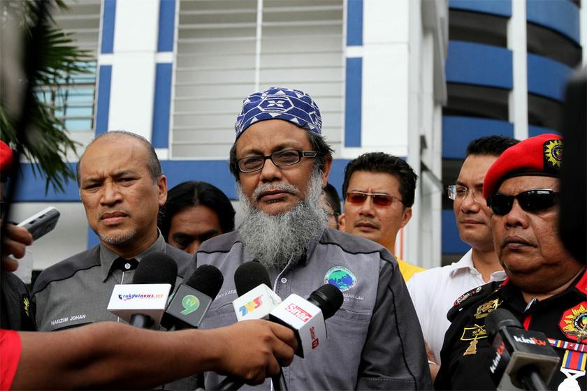 PPIM activist, Sheikh Abd Karemm S Khadaied (centre), PPIM President, Datuk Nadzim Johan (left) and MJMM President, Abdul Rani Kulup Abdullah speaks to reporters after lodging a police report against Cadbury in Dang Wangi, Kuala Lumpur on June 4, 2014. u00e2u20ac