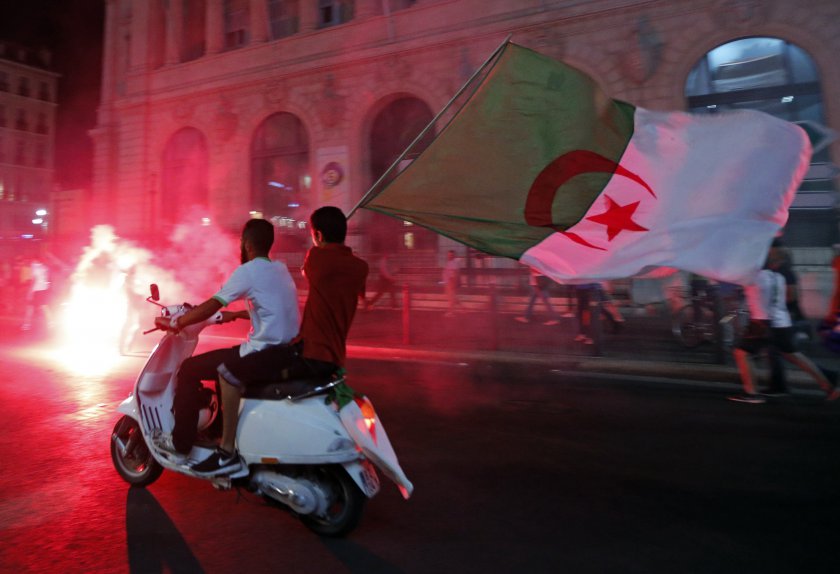 Algerian football fans hold their national flags as they celebrate after the end of Algeriau00e2u20acu2122s 2014 World Cup Group H match against Russia, in Marseille June 26, 2014. u00e2u20acu201d Reuters pic