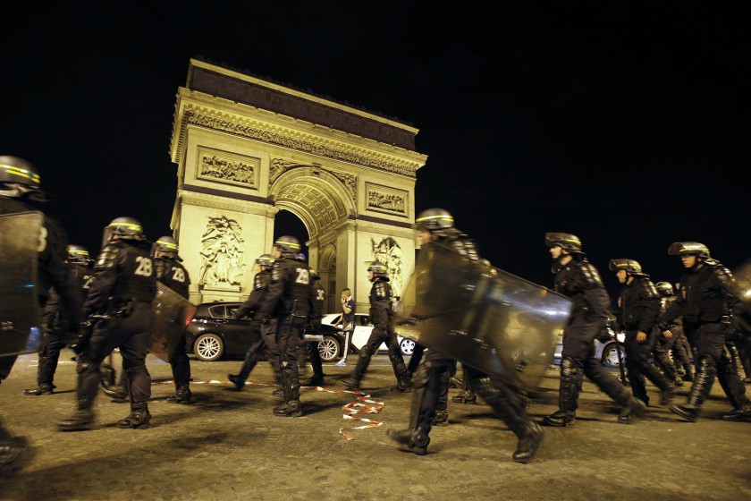 French CRS riot police officers secure the Arc de Triomphe as Algerian fans celebrate after Algeriau00e2u20acu2122s 2014 World Cup Group H match against Russia, in Paris early June 27, 2014. u00e2u20acu201d Reuters pic