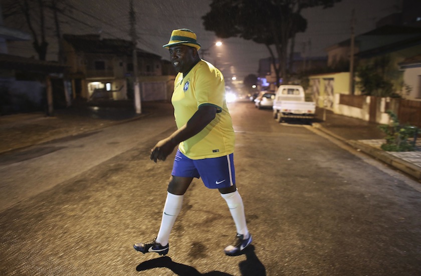 Bus driver Edilson, 45, also known as 'Fumassa', walks towards an urban bus decorated with the colours of the Brazilian flag and 2014 World Cup motifs, in Santo Andre, on the outskirts of Sao Paulo June 18, 2014. u00e2u20acu201d Reuters pic