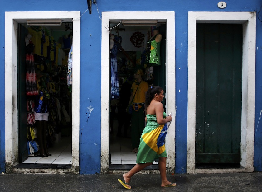 A woman wearing a dress with the Brazilian flag motif walks on a street in Pelourinho neighbourhood near the 2014 World Cup fan zone in Salvador, June 14, 2014.u00c2u00a0u00e2u20acu201d Reuters pic