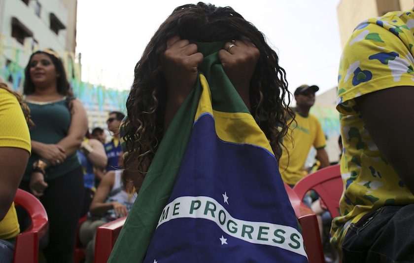 A Brazilian fan reacts as she holds a Brazilan flag during the 2014 World Cup round of 16 soccer match between Brazil and Chile at Bixiga neighbourhood at center of the city of Sao Paulo June 29, 2014.u00c2u00a0u00e2u20acu201d Reuters pic