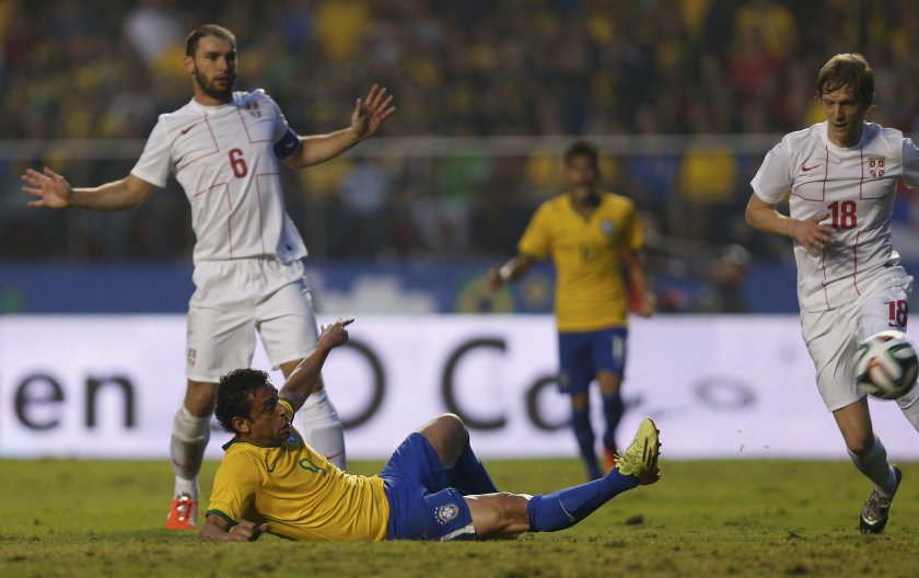 Brazilu00e2u20acu2122s Fred (centre) kicks the ball to score a goal as Serbiau00e2u20acu2122s Branislav Ivanovic (left) and Dusan Basta watch, during their international friendly match ahead of the 2014 World Cup in Morumbi stadium in Sao Paulo, June 6, 2014. u00e2u20acu201d Reuters pic